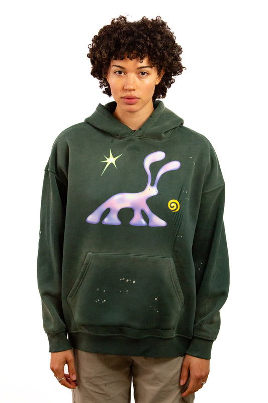 Light skinned androgynous model with natural curly hair wearing shirt in Jasper green