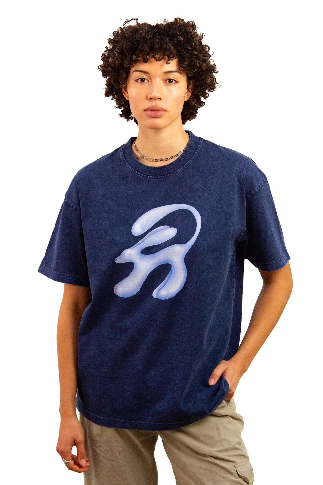 Light skinned androgynous model with natural curly hair wearing shirt in Ink blue