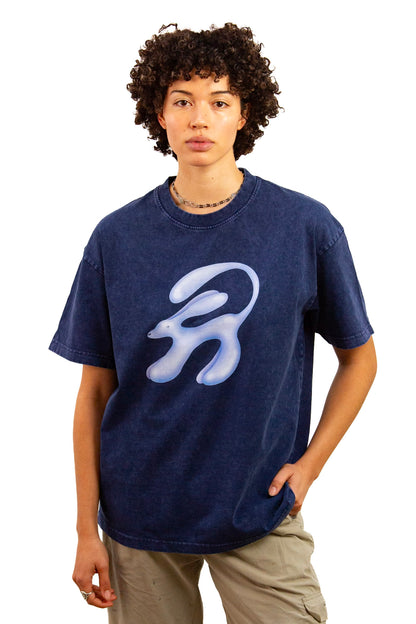 Light skinned androgynous model with natural curly hair wearing shirt in Ink blue