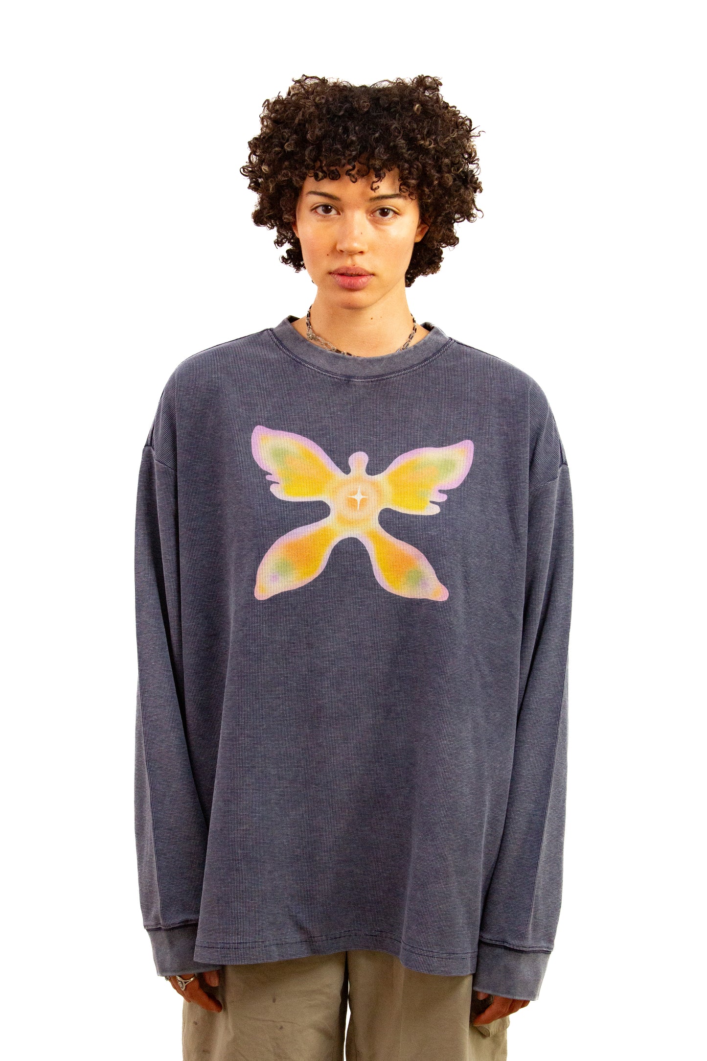 Light skinned androgynous model with natural curly hair wearing shirt in Washed indigo