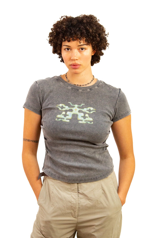 Light skinned androgynous model with natural curly hair wearing shirt in Storm grey