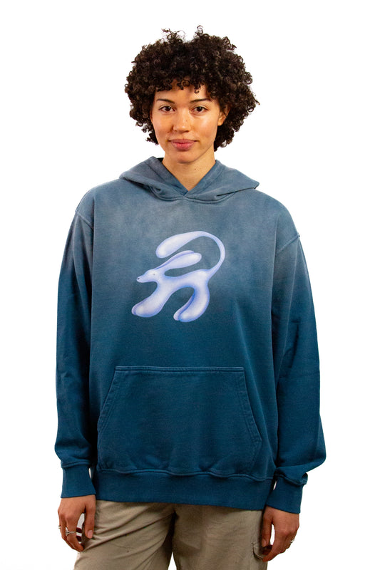 Light skinned androgynous model with natural curly hair wearing shirt in Faded denim