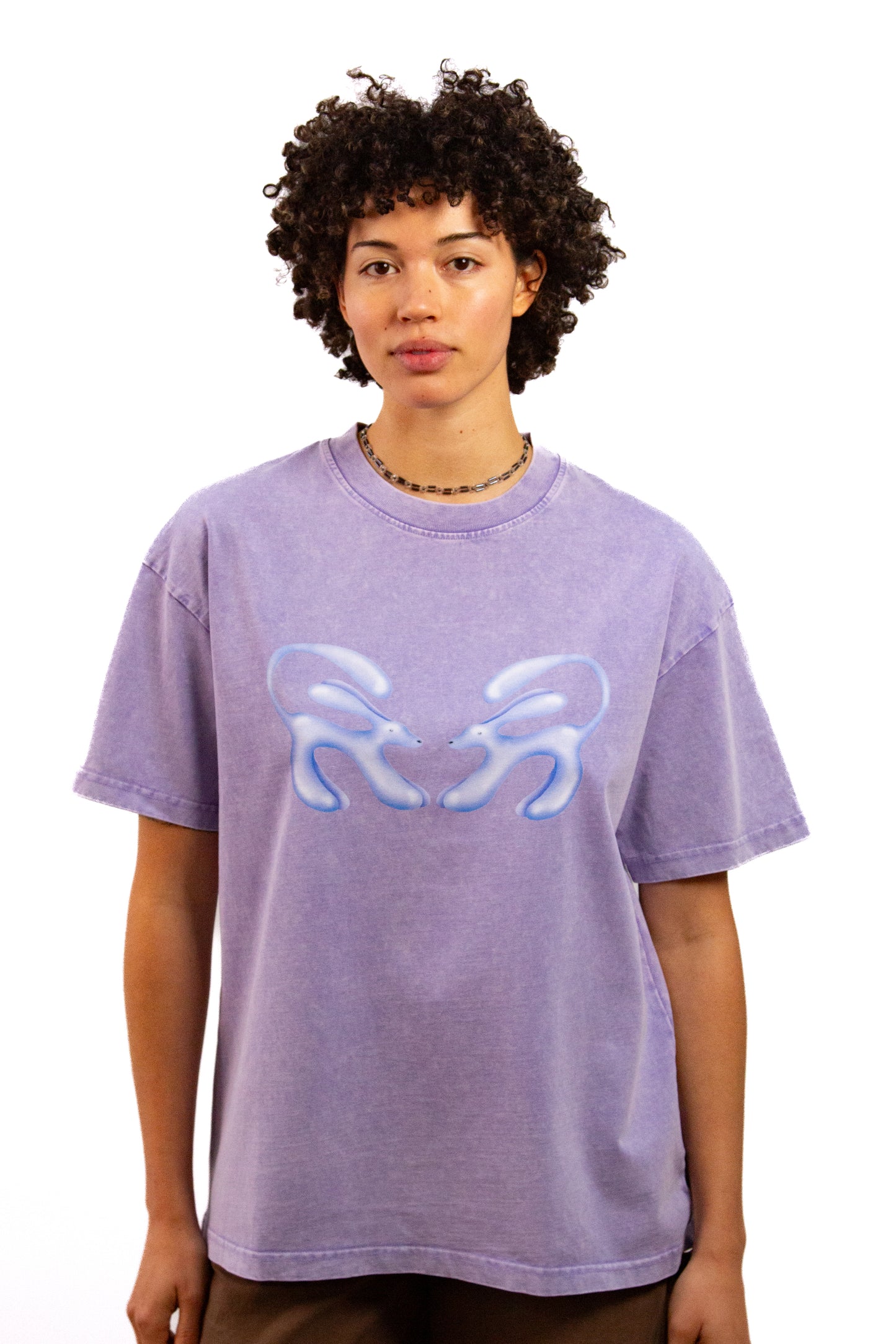Light skinned androgynous model with natural curly hair wearing shirt in Lilac
