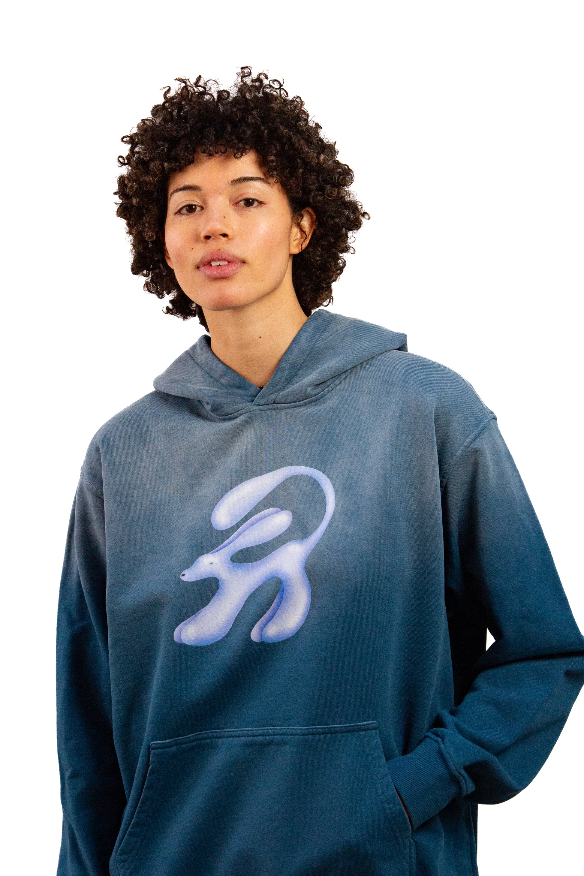 Light skinned androgynous model with natural curly hair wearing shirt in Faded denim