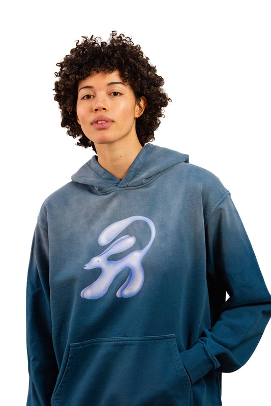 Light skinned androgynous model with natural curly hair wearing shirt in Faded denim