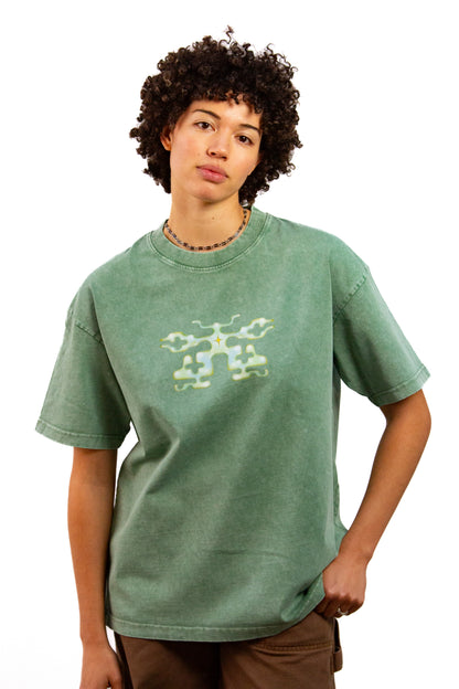 Light skinned androgynous model with natural curly hair wearing shirt in Mossmilk